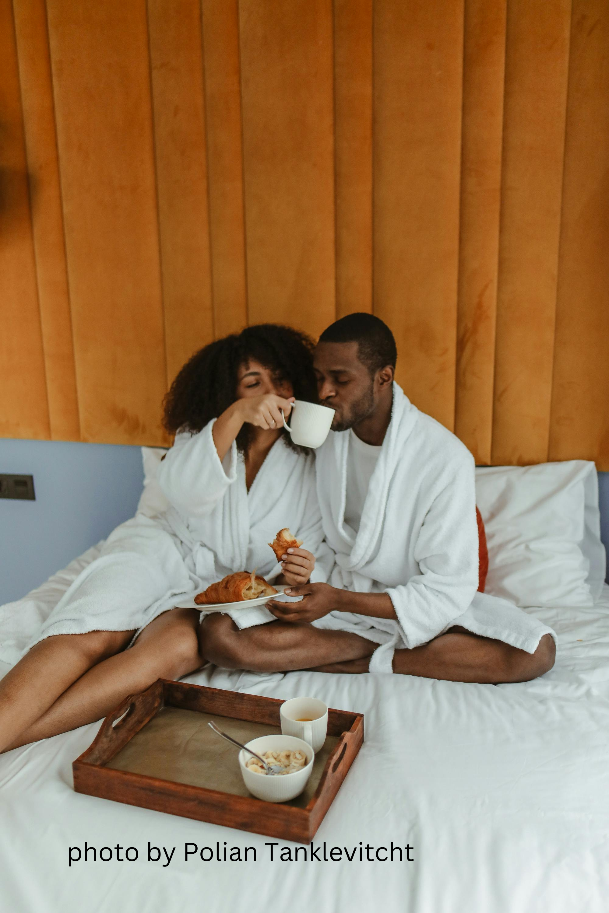 couple enjoying breakfast in bed, honeymoon