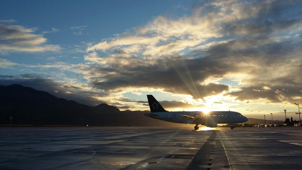 airplane landing during sunset 