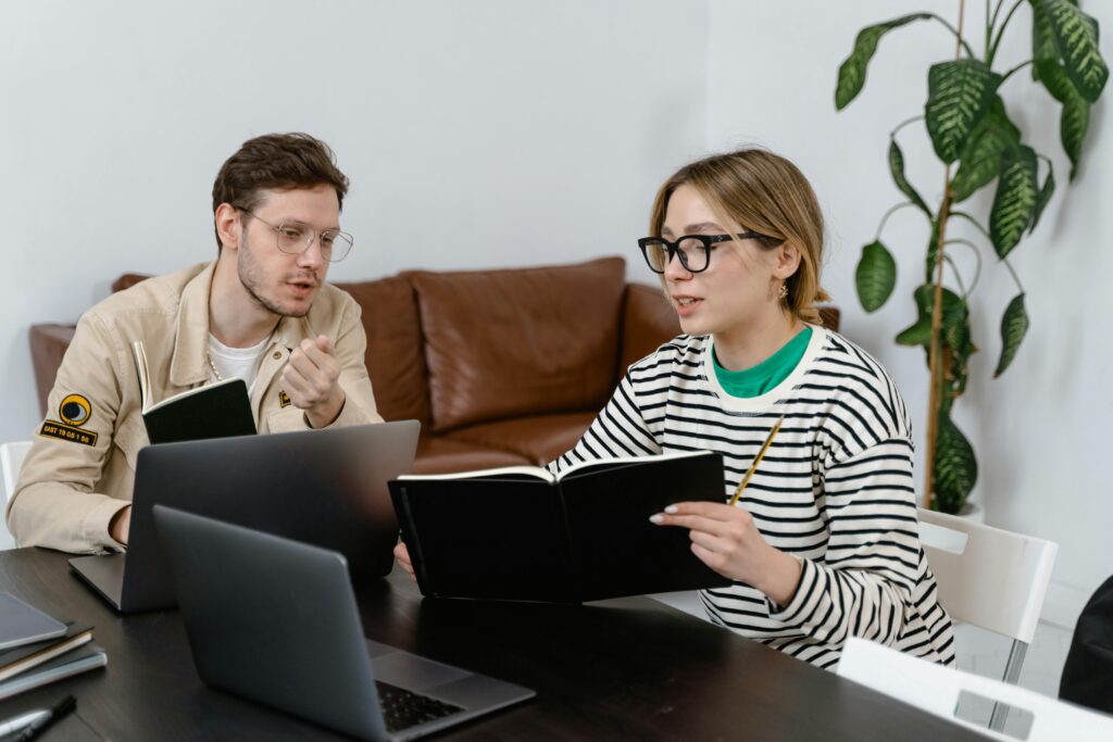 man and women on computer researching wedding resorts